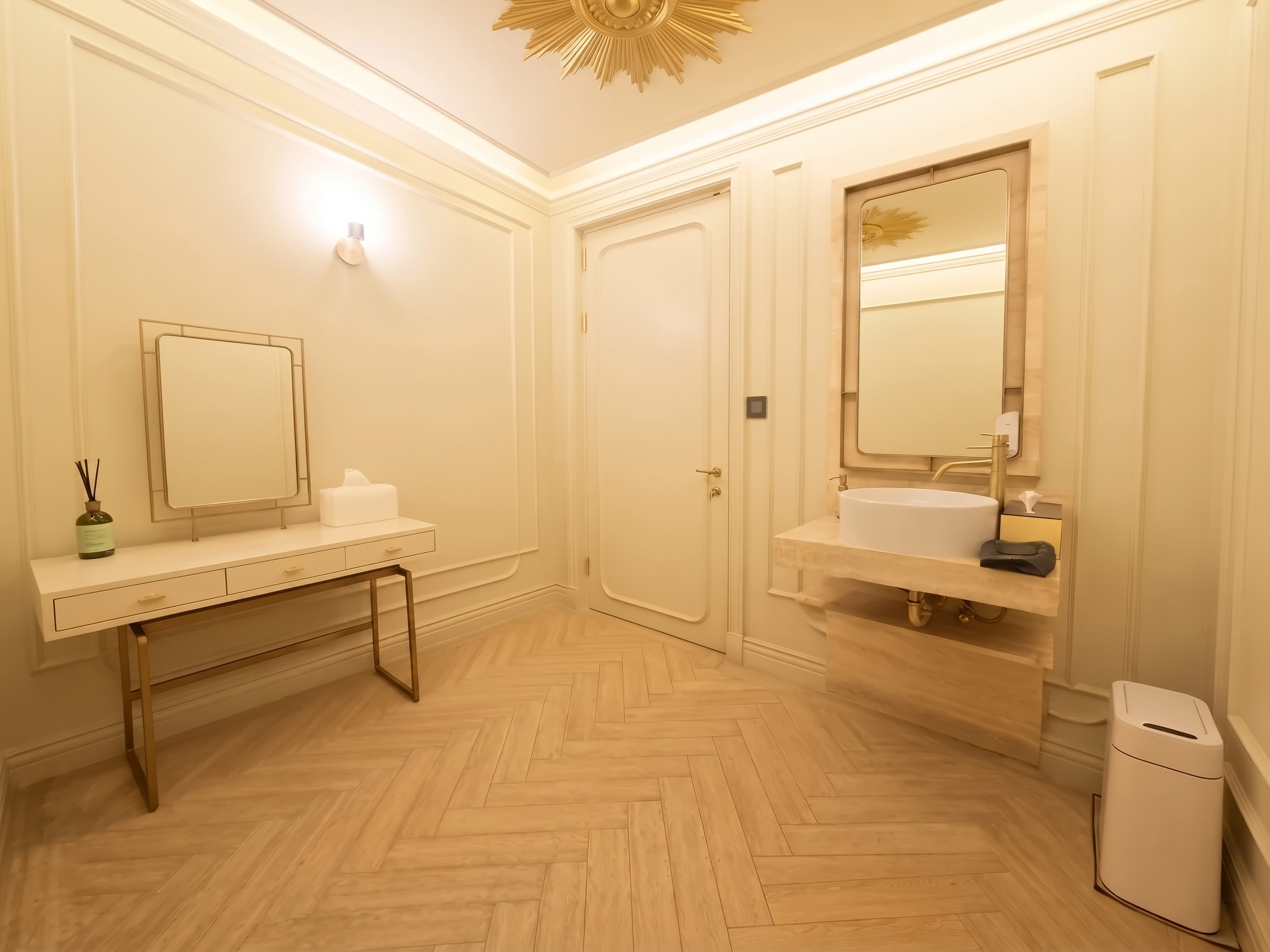 Powder room finished in mouldings and brass detail